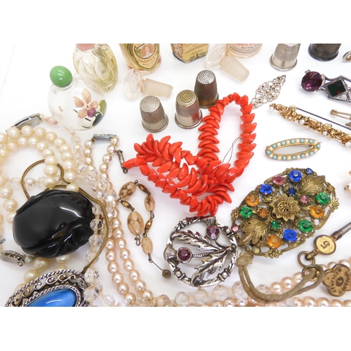 902 - Vintage perfume bottles, a gold plated manicure set, and a quantity of costume jewellery to include ... 