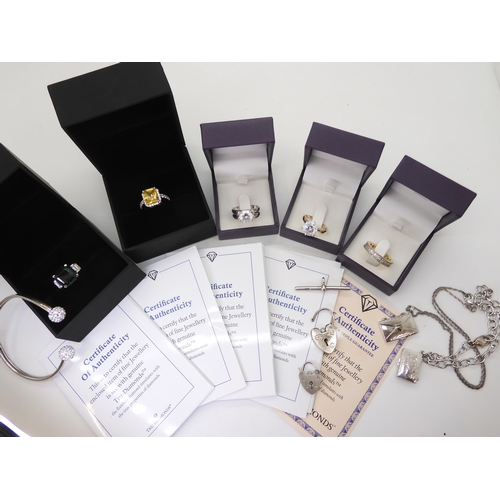 910 - Five pieces of jewellery set with 'Tru-Diamonds' simulated diamonds with certificated, two silver pa... 