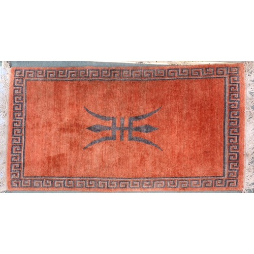 100 - A terracotta ground Kangri rug with Greek key style border, 180cm long x 92cm wide and another small... 