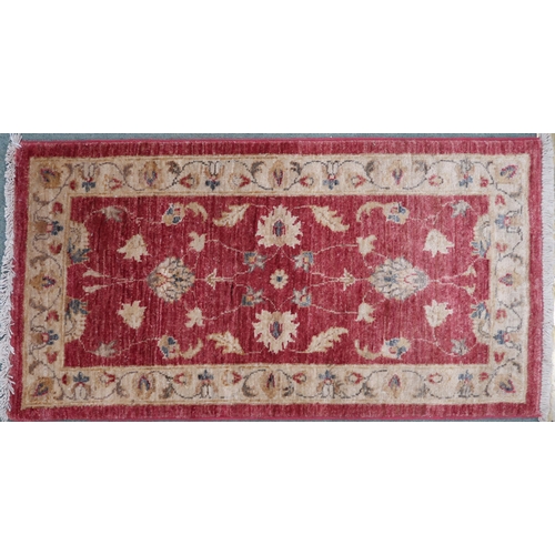 100 - A terracotta ground Kangri rug with Greek key style border, 180cm long x 92cm wide and another small... 