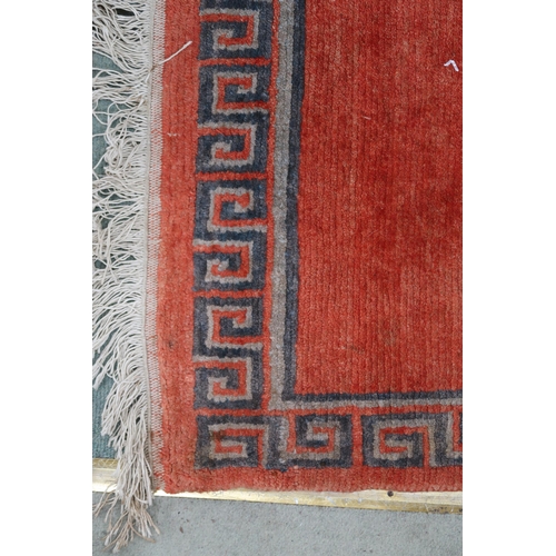 100 - A terracotta ground Kangri rug with Greek key style border, 180cm long x 92cm wide and another small... 