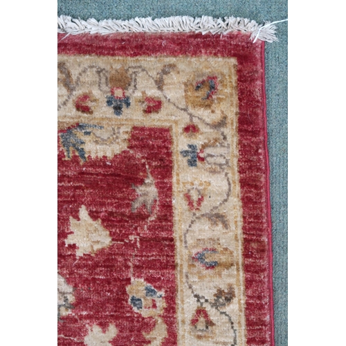 100 - A terracotta ground Kangri rug with Greek key style border, 180cm long x 92cm wide and another small... 