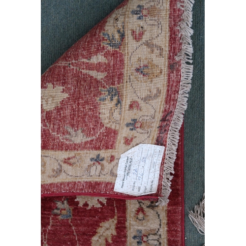 100 - A terracotta ground Kangri rug with Greek key style border, 180cm long x 92cm wide and another small... 