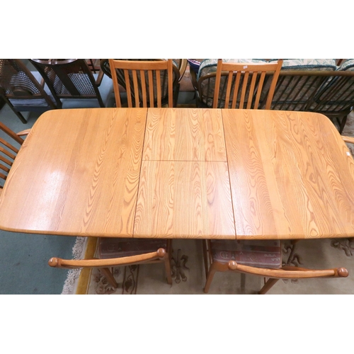 109A - A contemporary Ercol elm and beech dining suite comprising extending dining table, 74cm high x 151cm... 