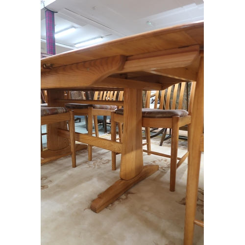 109A - A contemporary Ercol elm and beech dining suite comprising extending dining table, 74cm high x 151cm... 