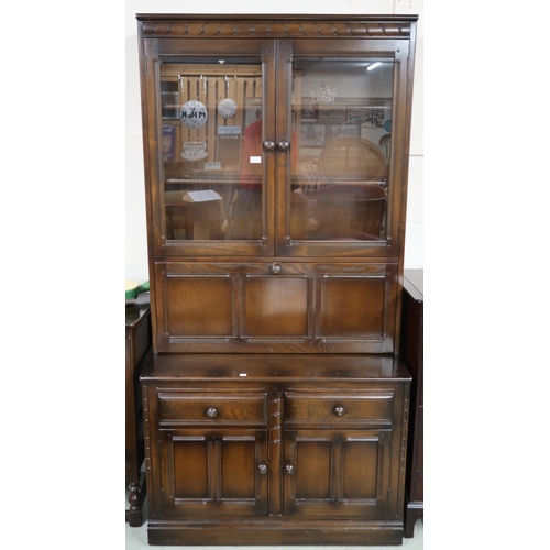 115 - A 20th century Ercol elm and beech bureau bookcase with pair of glazed doors over fall front compart... 