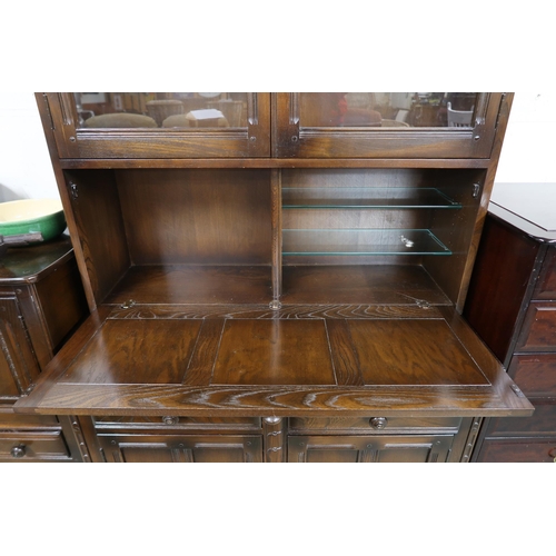 115 - A 20th century Ercol elm and beech bureau bookcase with pair of glazed doors over fall front compart... 