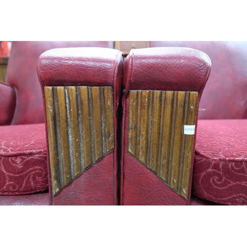 138 - A pair of early 20th century art deco red Rexine upholstered club armchairs, 80cm high x 74cm wide x... 