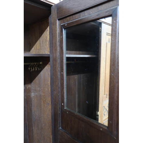 143 - An early 20th century oak Arts and Crafts style two door wardrobe, 195cm high x 111cm wide x 44cm de... 