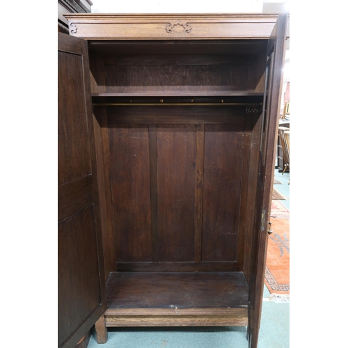 143 - An early 20th century oak Arts and Crafts style two door wardrobe, 195cm high x 111cm wide x 44cm de... 