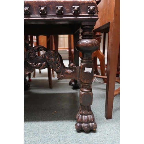 16 - A Victorian stained oak framed Baronial style hall chair with leather back and seat embossed with ar... 