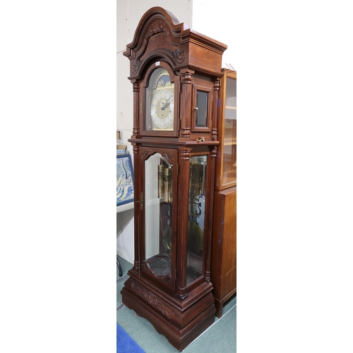 176 - A 20th century mahogany cased longcase clock with arched brass and silvered dial bearing Arabic nume... 