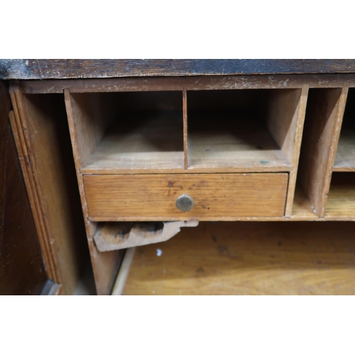 23 - An early 20th century oak tambour top desk with fitted interior over single long drawer alongside ba... 