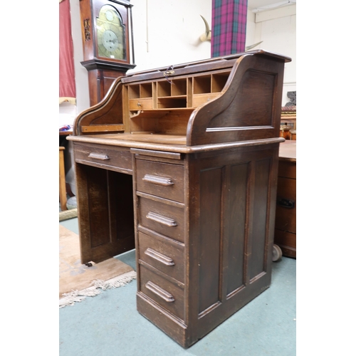 23 - An early 20th century oak tambour top desk with fitted interior over single long drawer alongside ba... 