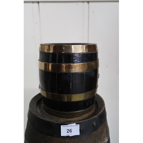 26 - An ironed banded coopered barrel, a smaller coopered wine cask with spigot and a small brass banded ... 
