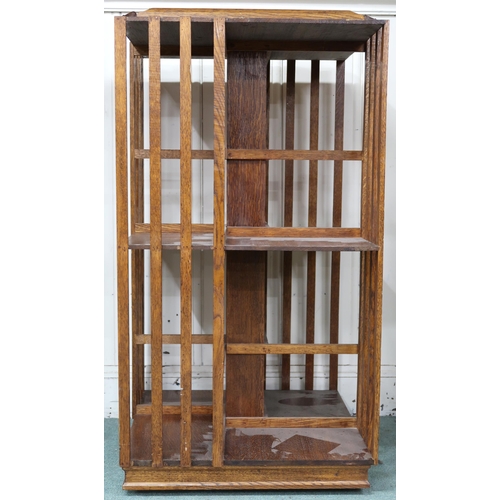 30 - An early 20th century oak two tier revolving bookcase with moulded gallery top, 118cm high x 63cm wi... 