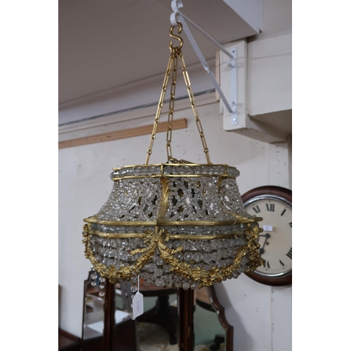 37A - An early 20th century Louis XVI style basket chandelier with cast brass floral swags joined by inter... 