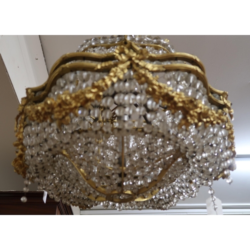 37A - An early 20th century Louis XVI style basket chandelier with cast brass floral swags joined by inter... 