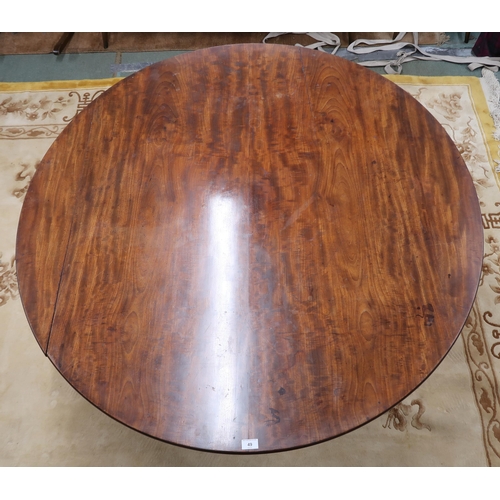 49 - A Georgian mahogany circular tilt top breakfast table on turned column quadrupedal base terminating ... 