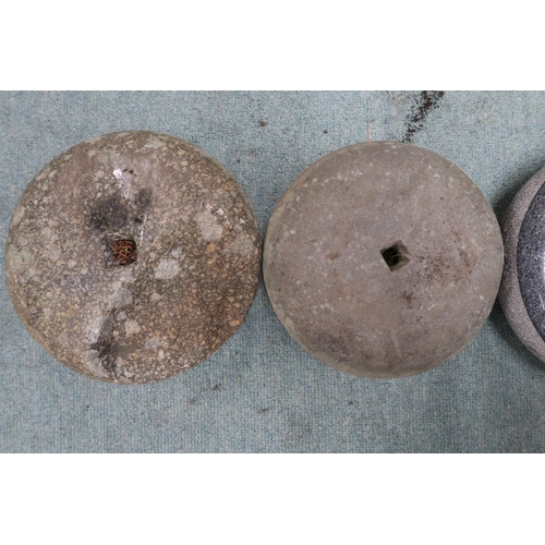 52 - A pair of Scottish curling stones with steel and wood handles and a further assorted two lacking han... 