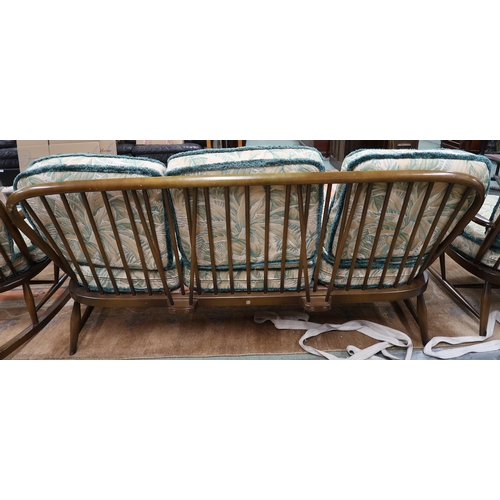 54 - A mid 20th century Ercol elm and beech framed three piece suite comprising three seater settee, 78cm... 