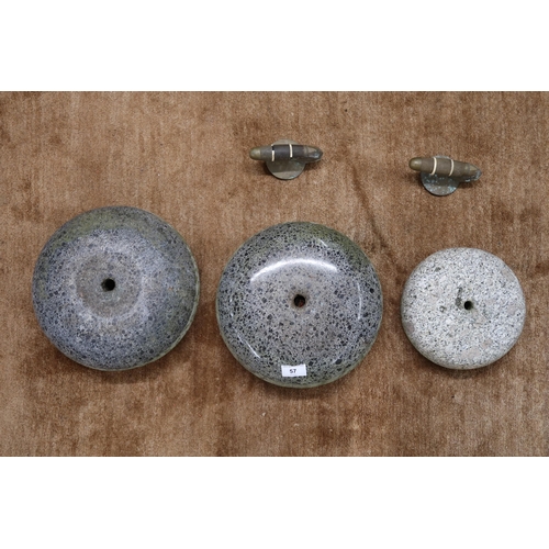57 - A pair of Scottish polished curling stones with detached handles and another smaller curling stone (... 