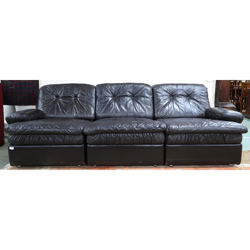 59 - A mid 20th century after Tetrad sectional three seater sofa with black patchwork leather upholstery,... 