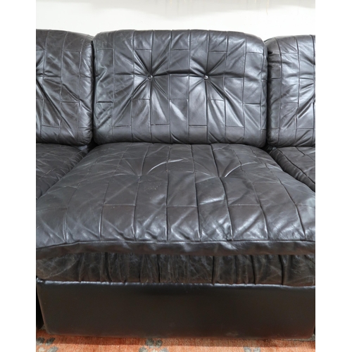 59 - A mid 20th century after Tetrad sectional three seater sofa with black patchwork leather upholstery,... 