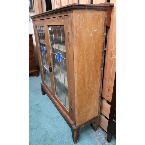 71 - An early 20th century oak arts and crafts style glazed bookcase with pair of leaded glass doors cent... 