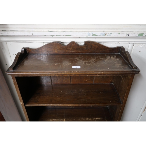 8 - An early 20th century oak open bookcase with three open shelves over fold down surface, 132cm high x... 