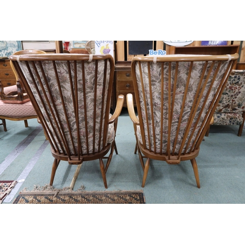 96 - A pair of mid 20th century Ercol elm and beech framed open armchairs with floral foliate upholstery,... 