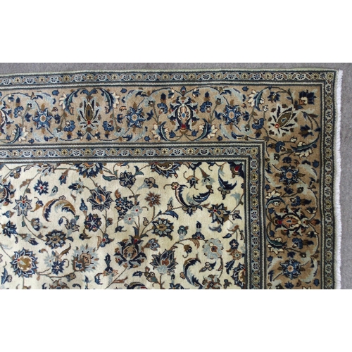 2132 - A CREAM GROUND KASHAN RUGwith all over floral ground and flower head border, 297cm long x 194cm wide... 