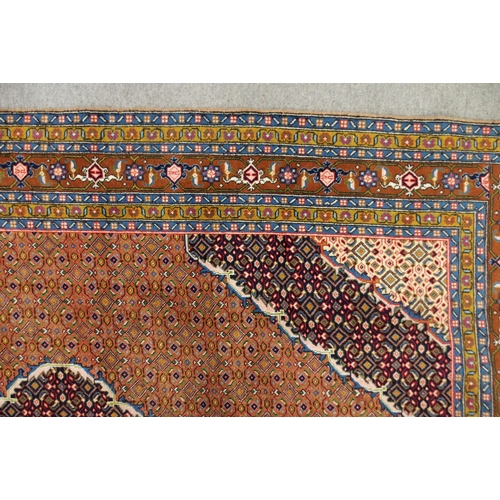 2136 - A COPPER GROUND TABRIZ GROUND RUGwith multicoloured central medallion, matching spandrels and multic... 