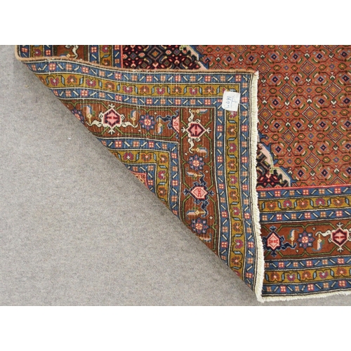 2136 - A COPPER GROUND TABRIZ GROUND RUGwith multicoloured central medallion, matching spandrels and multic... 