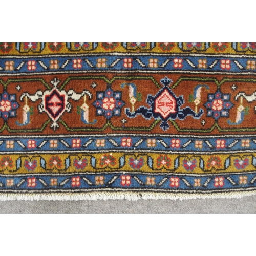 2136 - A COPPER GROUND TABRIZ GROUND RUGwith multicoloured central medallion, matching spandrels and multic... 