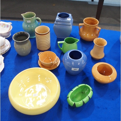 260 - A collection of Ashtead pottery including a soup coupe and saucer, vases, jugs and dishes in an asso... 