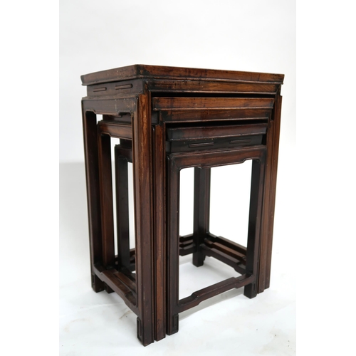 16 - A 19th century Chinese hardwood nest of three tables with rectangular tops on shaped square supports... 