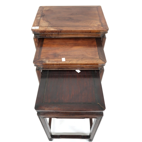 16 - A 19th century Chinese hardwood nest of three tables with rectangular tops on shaped square supports... 