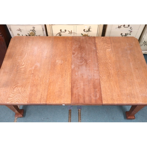 24 - A late Victorian oak arts and crafts style wind out extending dining table with two leaves (one unas... 