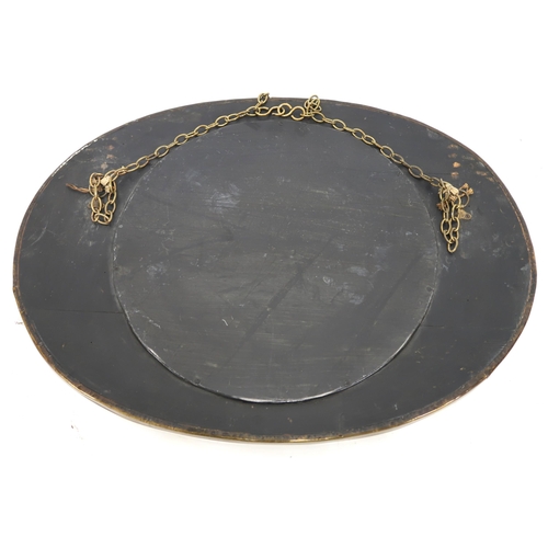 35 - An early 20th century British brass framed oval wall mirror with frame embossed foliate design aroun... 