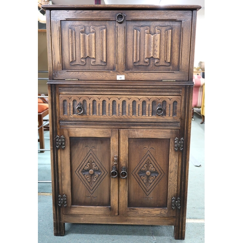 38 - A 20th century oak linen fold drinks cabinet with fall front drinks compartment over single drawer o... 