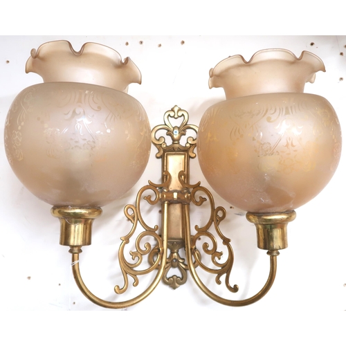 4 - A set of six 20th century brass two branch wall sconces with scroll decorated arms with opaque glass... 