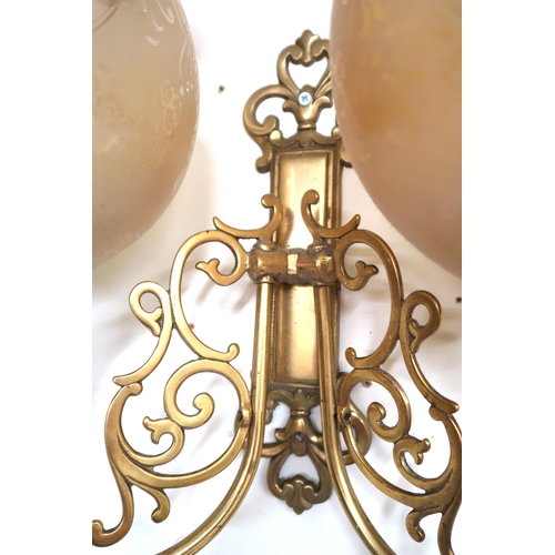 4 - A set of six 20th century brass two branch wall sconces with scroll decorated arms with opaque glass... 