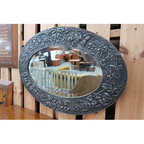 47 - A 20th century British school pewter framed oval wall mirror with embossed foliate design around ova... 