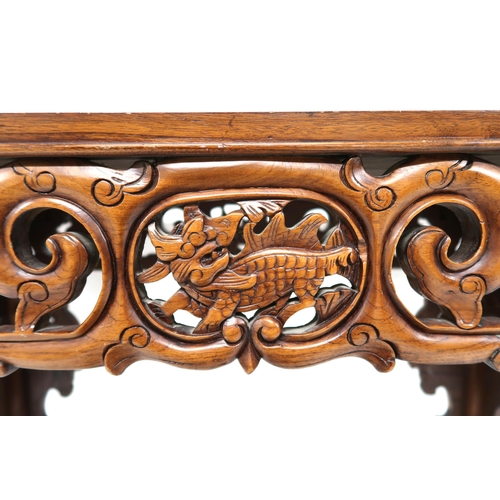 5 - A 20th century Oriental hardwood altar table with extensively carved pierced friezes over square sha... 