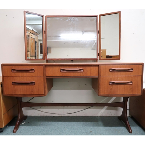 63 - A mid 20th century teak G Plan Fresco dressing mirror with three mirrors over single central drawer ... 