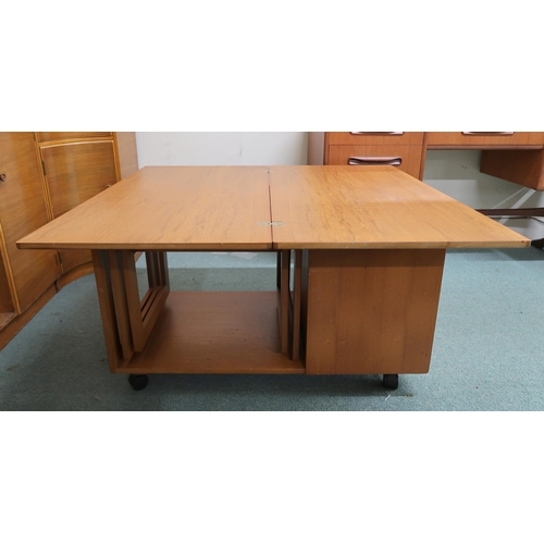 64 - A mid 20th century teak McIntosh Tristor fold over top coffee table with integrated nest of two tabl... 