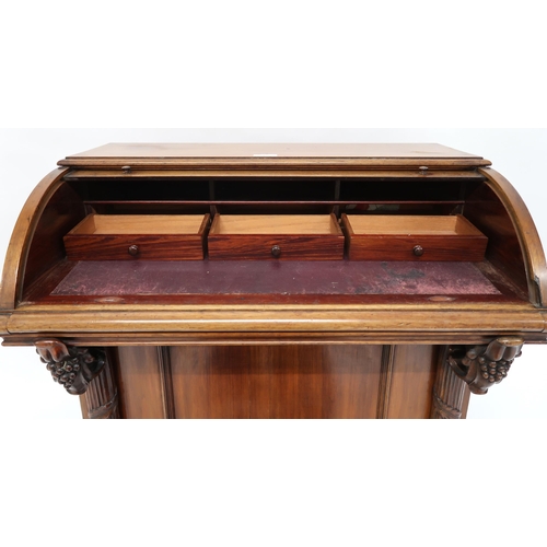 7 - A Victorian mahogany Davenport writing desk with cylinder top writing compartment over pair of carve... 