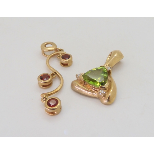 536 - A 9ct gold peridot and diamond pendant, together with a red gem set pendant , weight together 5.4gms