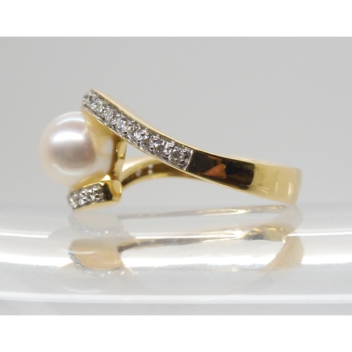 2793 - A DIAMOND AND PEARL RINGmounted in 18ct yellow gold the 7.6mm pearl is flanked with two rows of bril... 